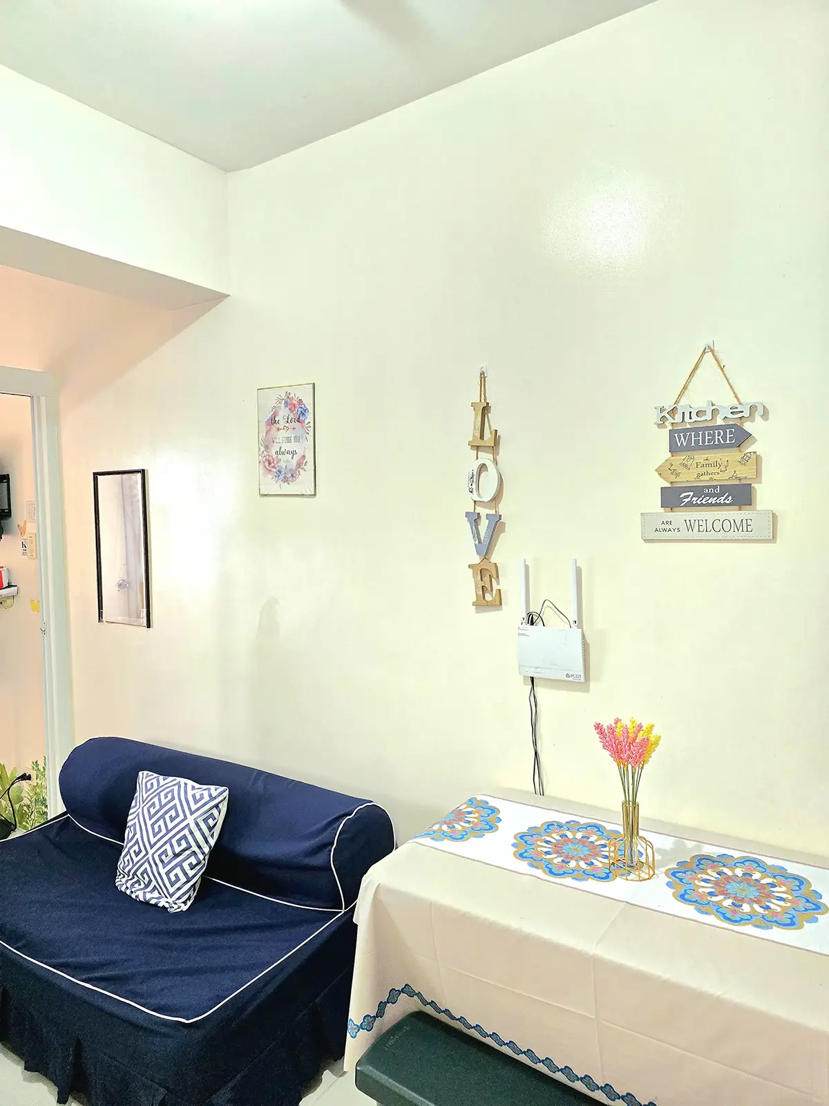 Navy sofa bed along the bright entrance and living area
